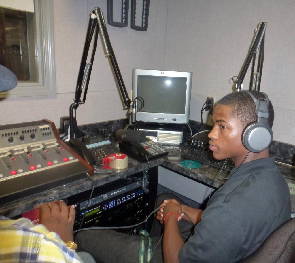Sound check:  Senior Jacob Studdard gets a lesson on the equipment in Radio class. 