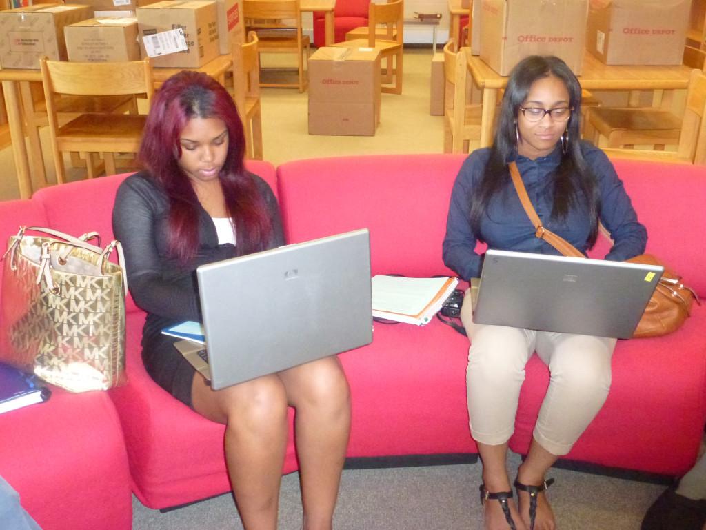 College goal: Seniors Aliyah Houston and McKenzie Lowry use the school library’s laptop computers to research colleges. Houston and Lowry say they both plan to apply to Michigan State University. 