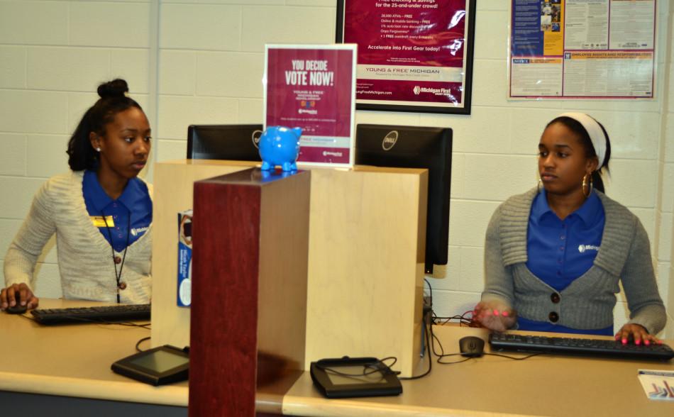 Pay Day: Bank tellers Nijah McNeal and Simone Mosby work as tellers at Michigan First Credit Union. Their position ends with the school year.