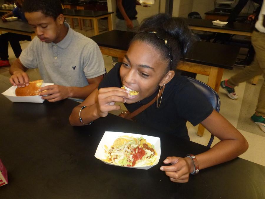 Lunch bunch: Junior Teka Richardson nibbles on nachos at lunchtime in the cafeteria. Beside her is senior Jeremy Gates.