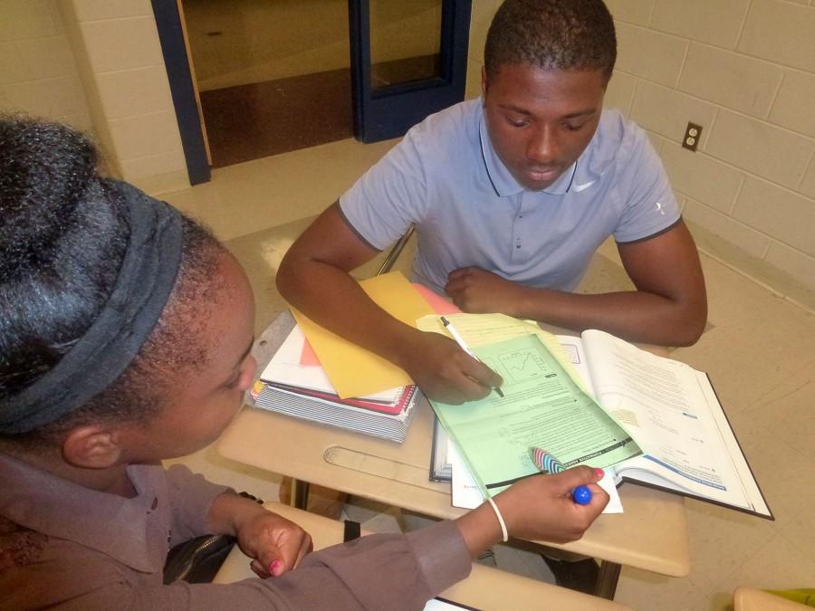National Honor Society member Shayla Smith, a junior, tutors junior Don Griffin  with math homework.