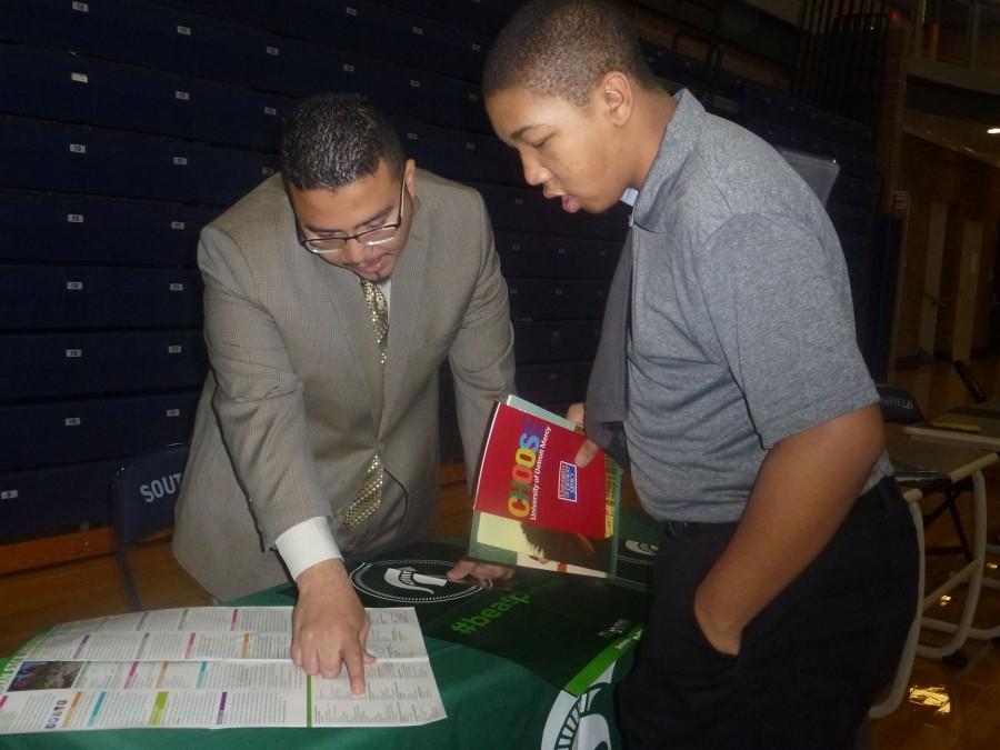 Choices: Sophomore Antoine Davis (above, right) consults with a Michigan State University representative.