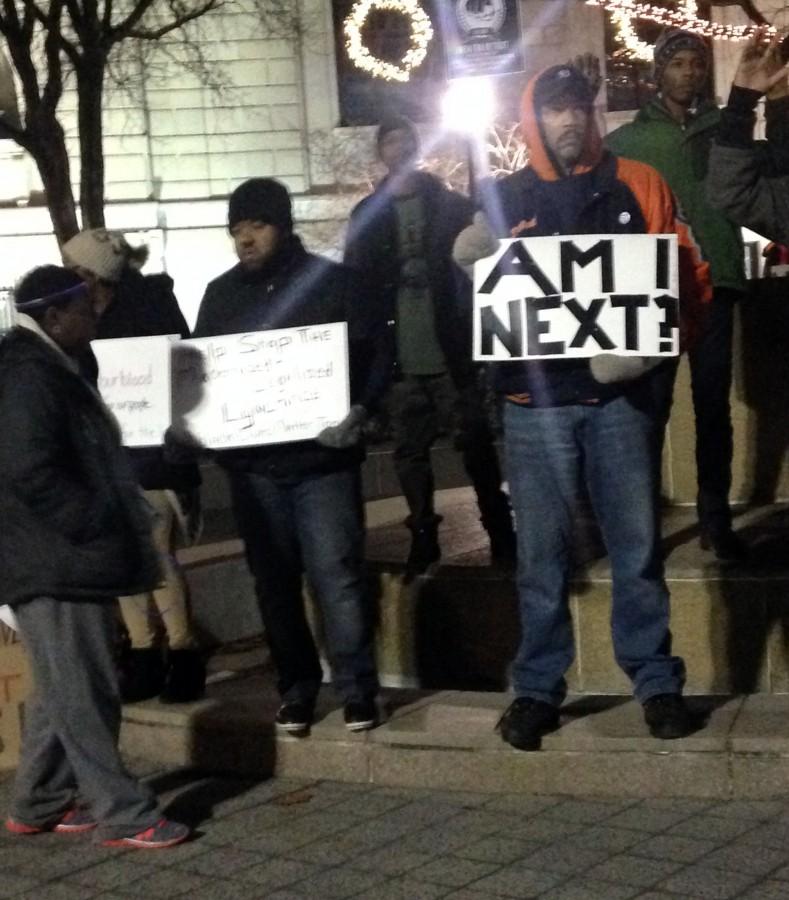 Sign+of+the+times%3A+A+protester+outside+the+Detriot+Institute+of+Arts+holds+a+sign+that+asks+if+he+will+be+the+next+black+man+to+die+from+a+police+shooting.