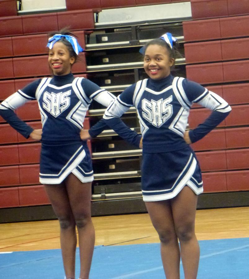 Members of the  Competitive Cheer team stand in the ready position before beginning each cheer. 