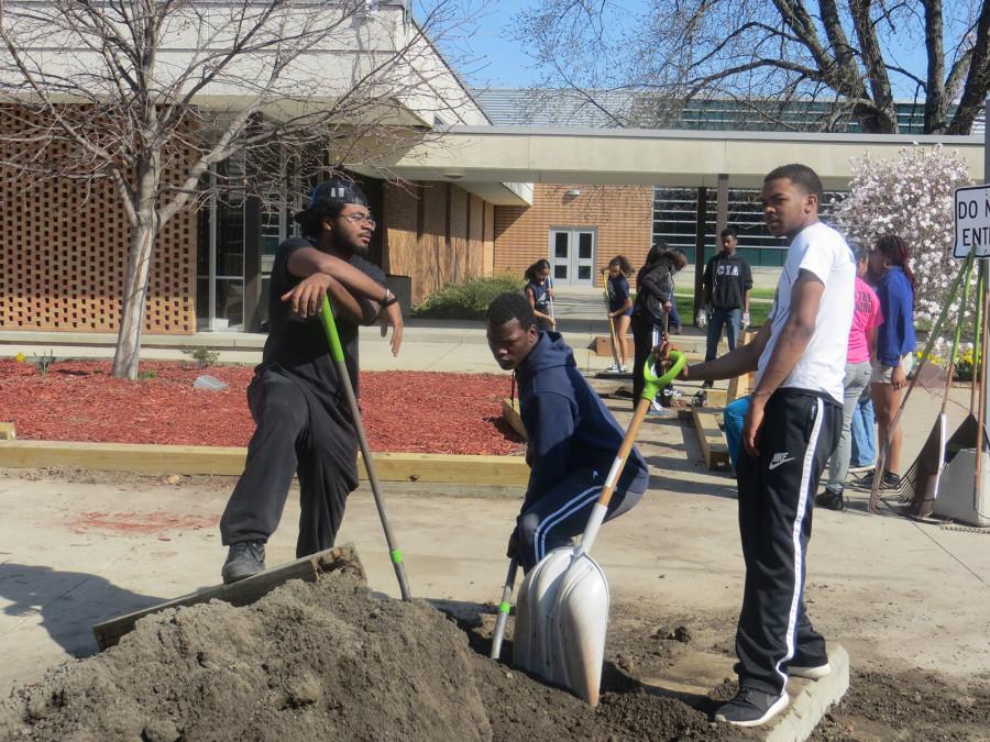 Adding new dirt to the Southfield High flower beds was part of Clean-Up Day. 
