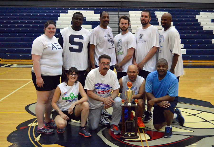 And the winner is . . . the faculty team, for the sixth year in a row. Pictured are  (front row, from left) science teacher Bailey Gamble, math teacher Steve Sharp, Chartwells food service Coordinator Rodel Endaluz, Principal Michael Horn, (second row, standing, from left) science teacher Jennifer Bargardi, Coach Marlon Friendly, Administrator Earl Dixson, student teacher Eric Lorber, social studies teacher Jamie Glinz and  Pianist Devon Cadwell.
