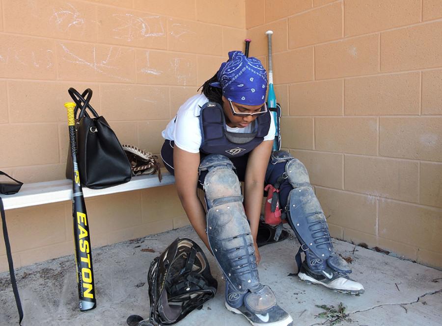 Catch me: Softball catcher Adriana Echols suits up between innings during a home game.