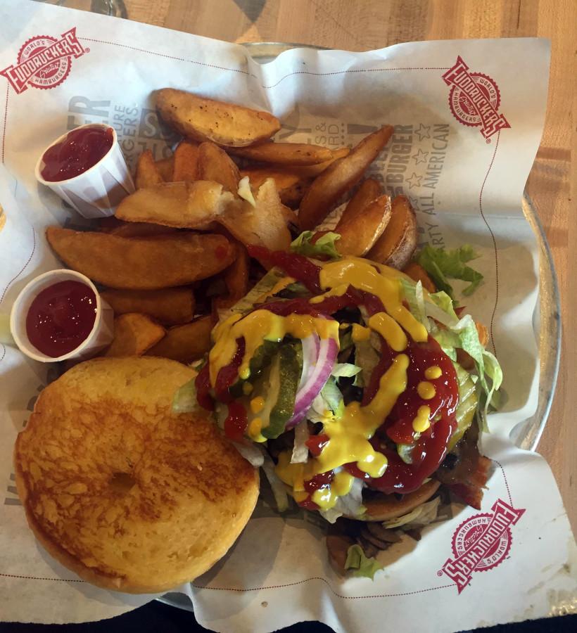 Burgers and fries - thats what Fuddruckers is known for. Pictured is the “The Works” - a burger with smokehouse bacon, American cheese and grilled mushrooms . Fries, too.