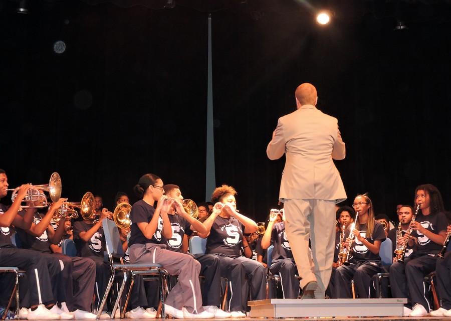Members of the marching band perform on stage instead of on the football field.