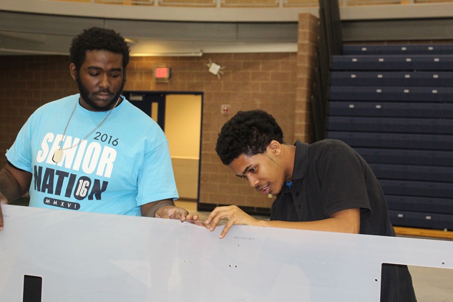 Senior Kaelan Owens (left) and senior Telvin Ayala prepare the drivers station for Robotics competition. Southfield High is hosting the competition for the third consecutive year.