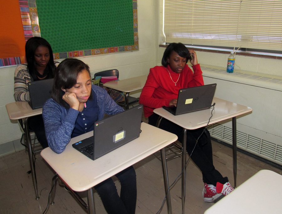 Computer time: Freshmen Davieana Mitchell (forefront), Amauri Brown (on right) and Sharday Tyler (back row) check out their new Chromebook computers during Semiar in Erin Reynoso’s Spanish classroom.